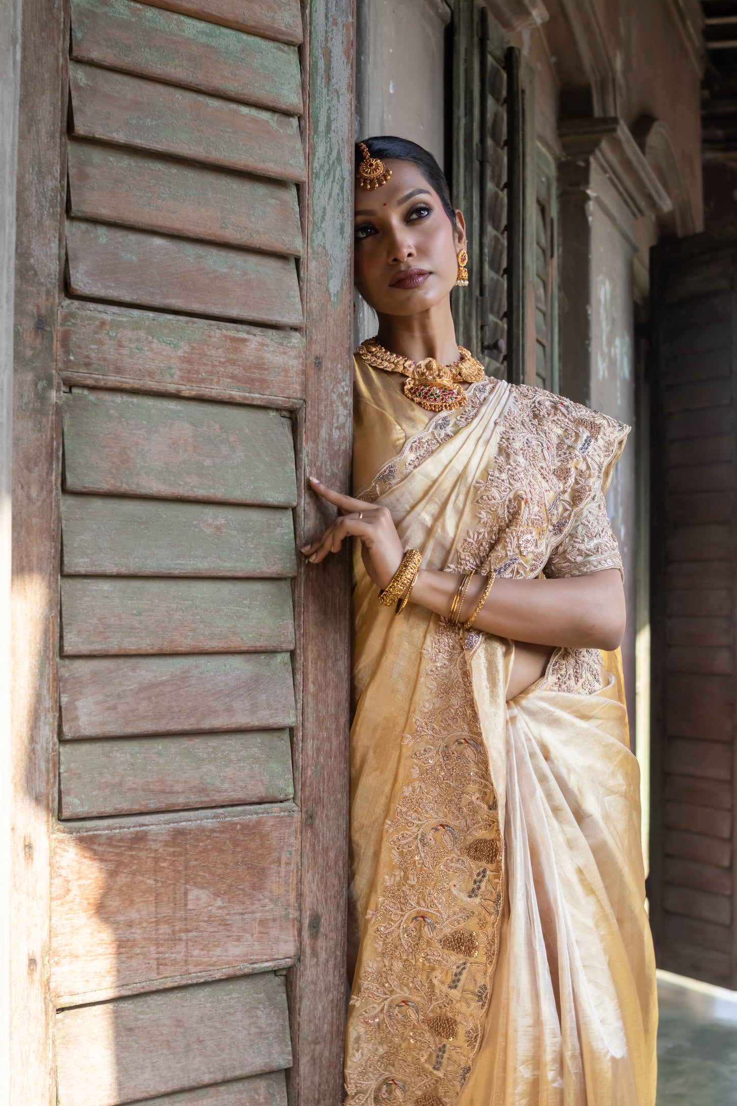 A PURE GOLD KANCHI TISSUE EMBROIDERED SAREE